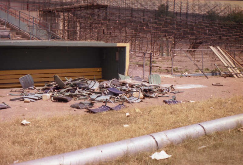 Pile of broken seat backs in front of the third base (visitors) dugout